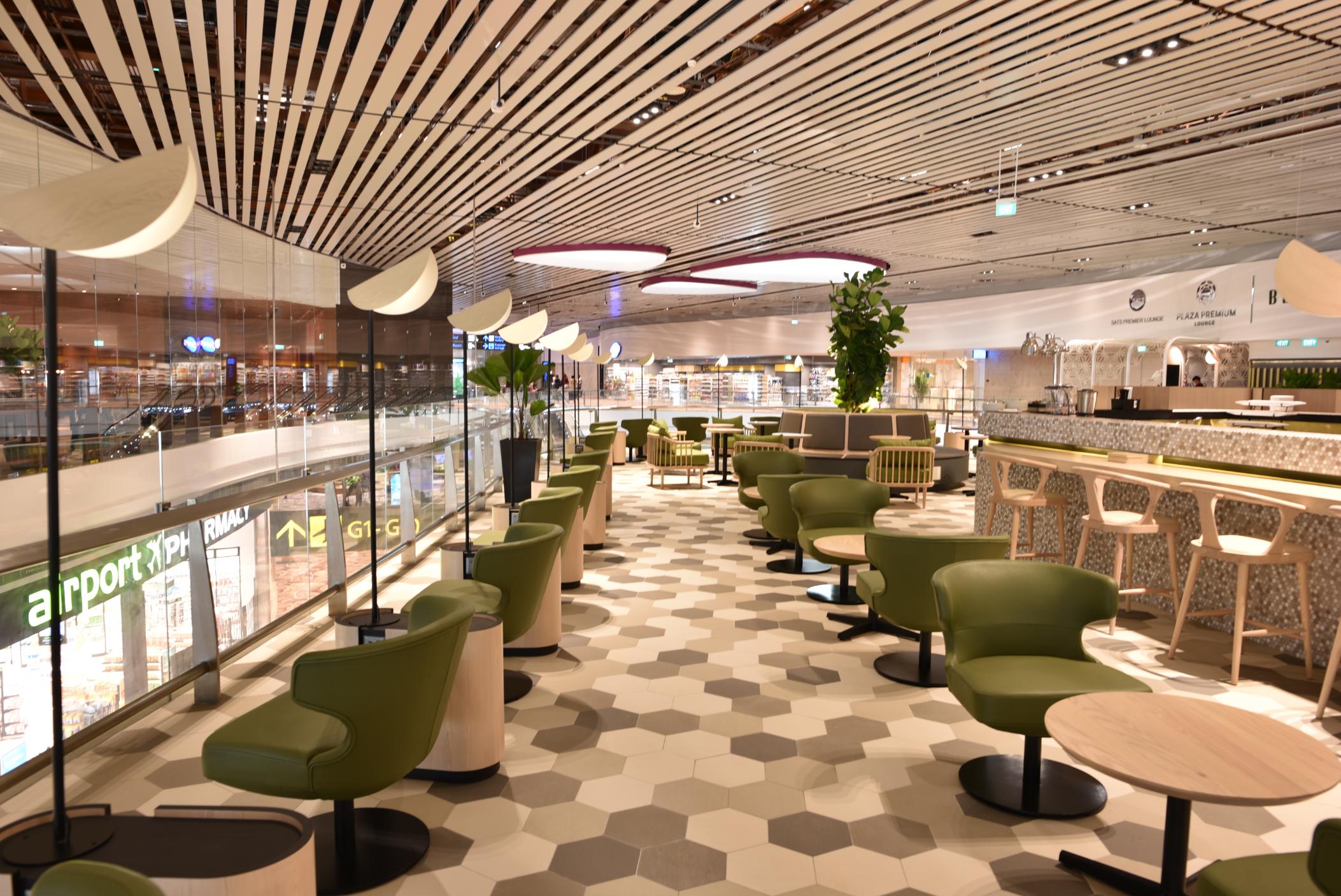 blossom-lounge-seating-near-walkway-green-chairs